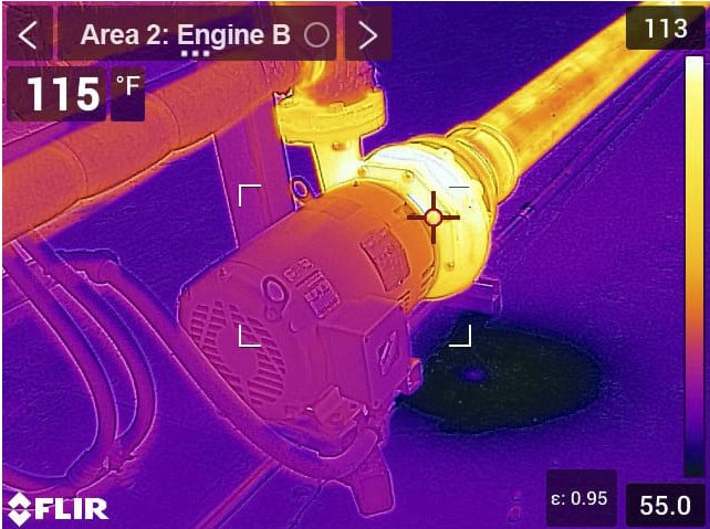 FLIR thermal image of a pump and connected pipework, with a spot measurement of 115 degrees Fahrenheit on the coupling and the surrounding pipe running hot.