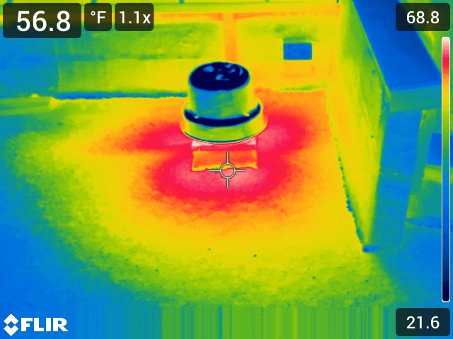 Thermal image of a roof penetration with a spot reading of 56.8 degrees Fahrenheit, scale 21.6 to 68.8. Heat radiates outward from the base of the vent in a red halo, indicating moisture spreading from the penetration.